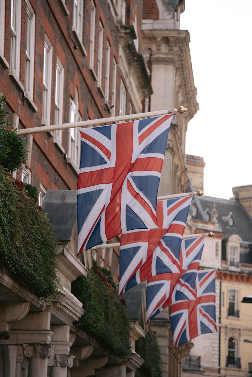 a row of british flags hanging from the side of a building