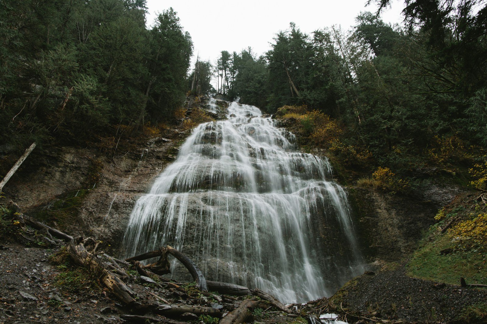 a large waterfall in the middle of a forest