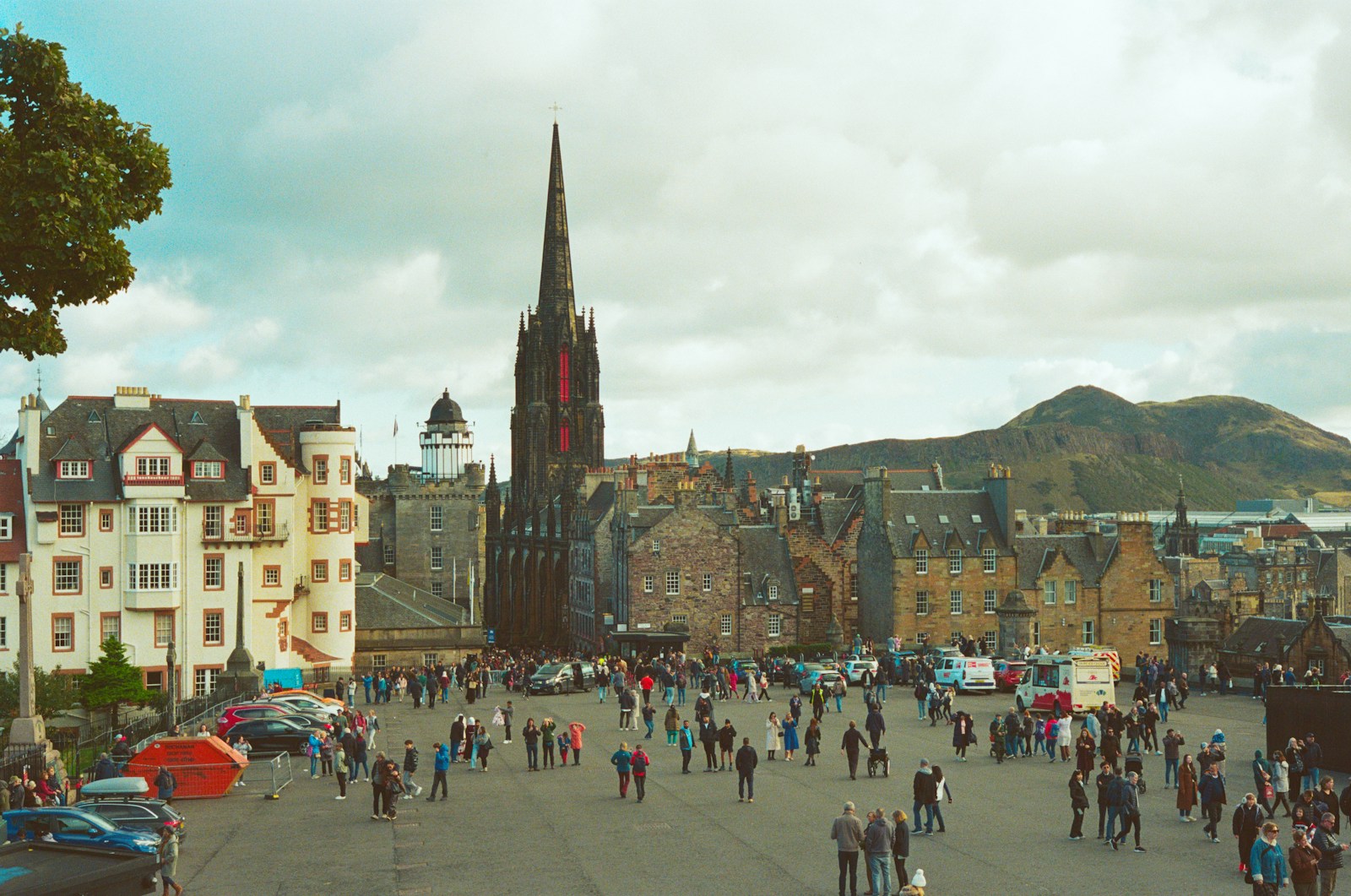 Crowded square in front of historic edinburgh buildings.