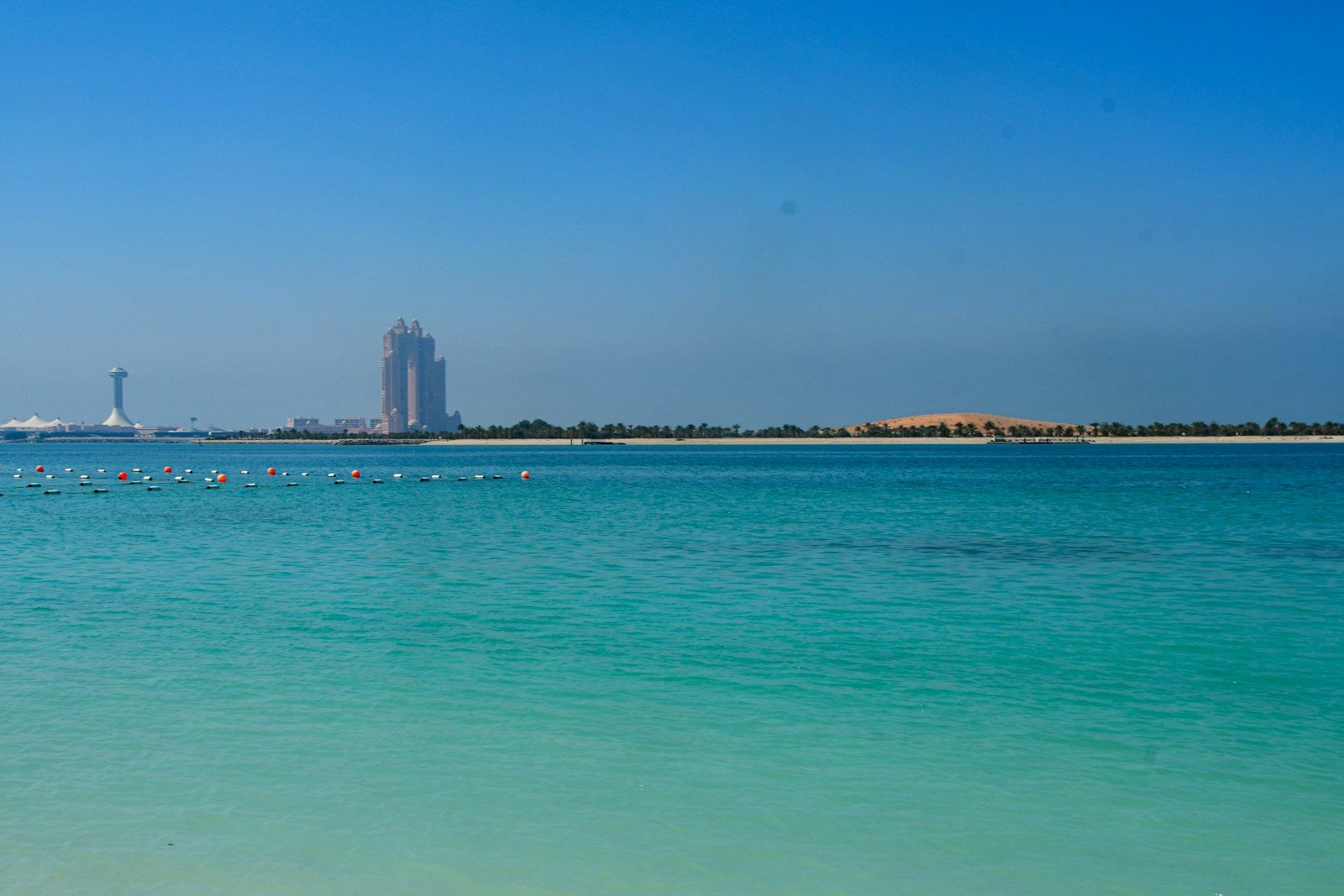 a large body of water with a tall building in the background
